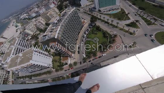 فيديو مثير: شاب متهور يستعرض مهاراته الخطيرة على حافة بناية شاهقة! صورة رقم 5
