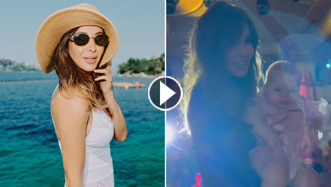 صور وفيديو: نانسي عجرم تحمل طفلة رضيعة على المسرح وتثير ضجة على الشاطئ